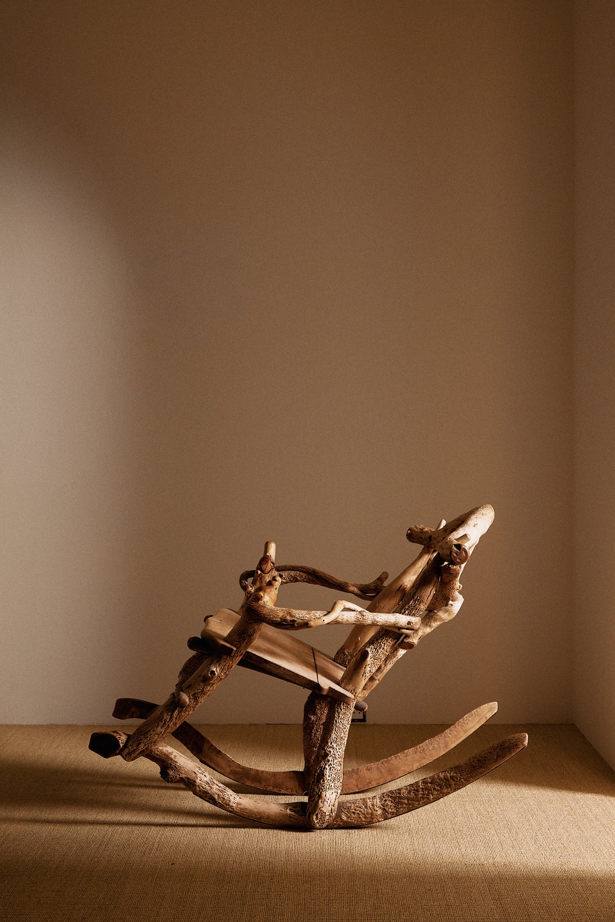 Matti Savijärvi tree root rocking chair, closer view with the chair rocked back