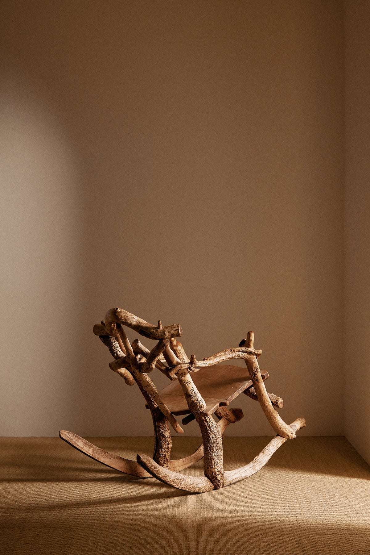 Matti Savijärvi tree root rocking chair, wide view with the chair rocked back