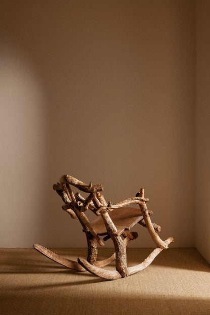 Matti Savijärvi tree root rocking chair, wide view with the chair rocked back