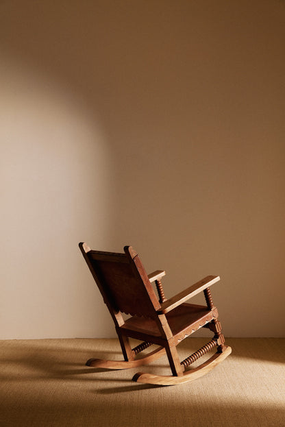 Mexican oak and tanned leather rocking chair, back angled view