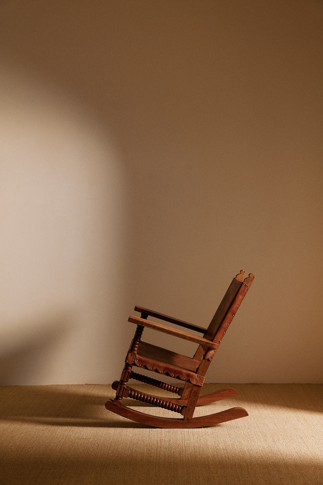Mexican oak and tanned leather rocking chair rear angled view