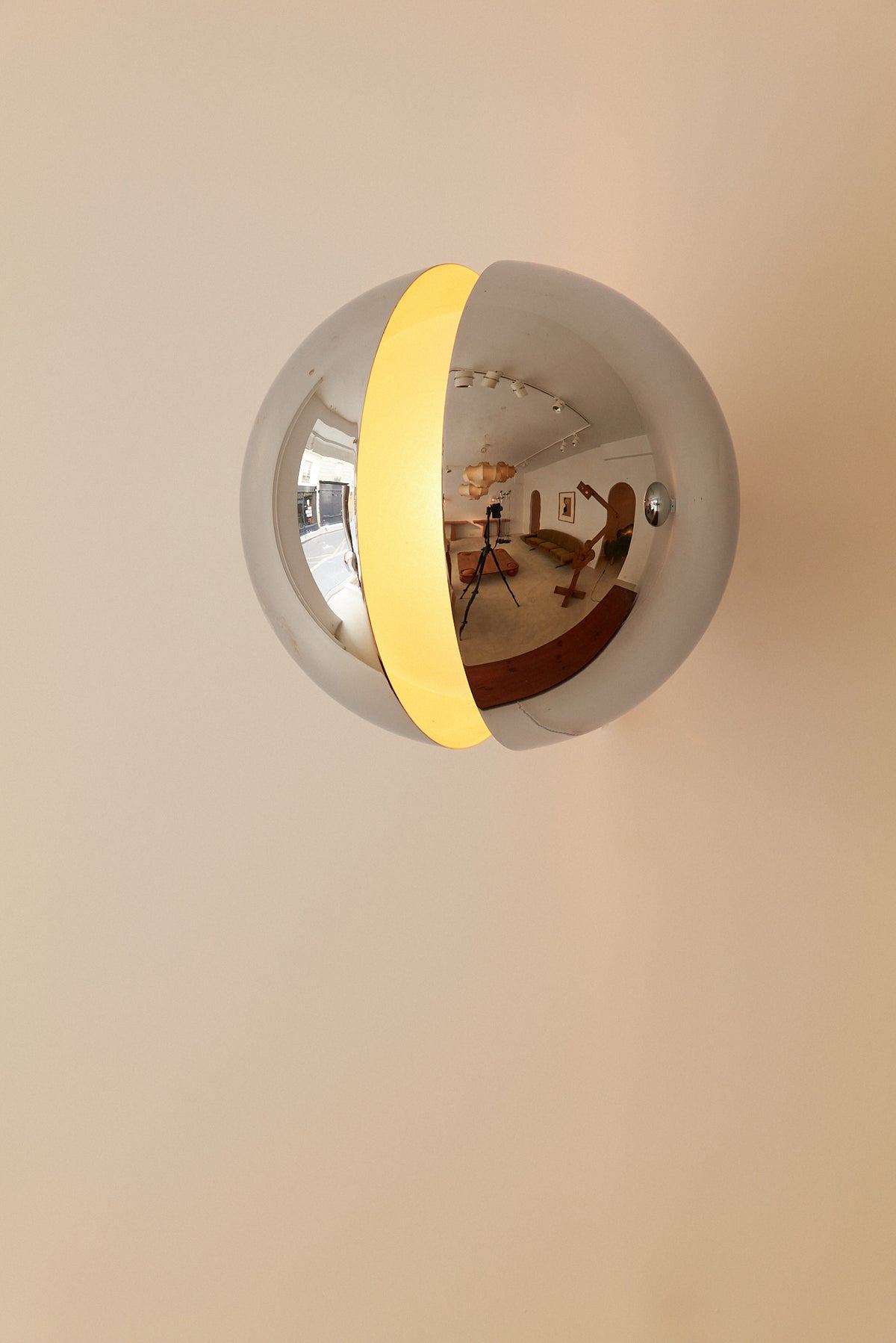 Gian Emilio, Piero & Anna Monti Diaframma polished steel and glass wall sconce, front view of the polished steel shell with the lit opening