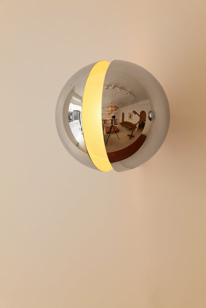 Gian Emilio, Piero & Anna Monti Diaframma polished steel and glass wall sconce, front view of the polished steel shell with the lit opening