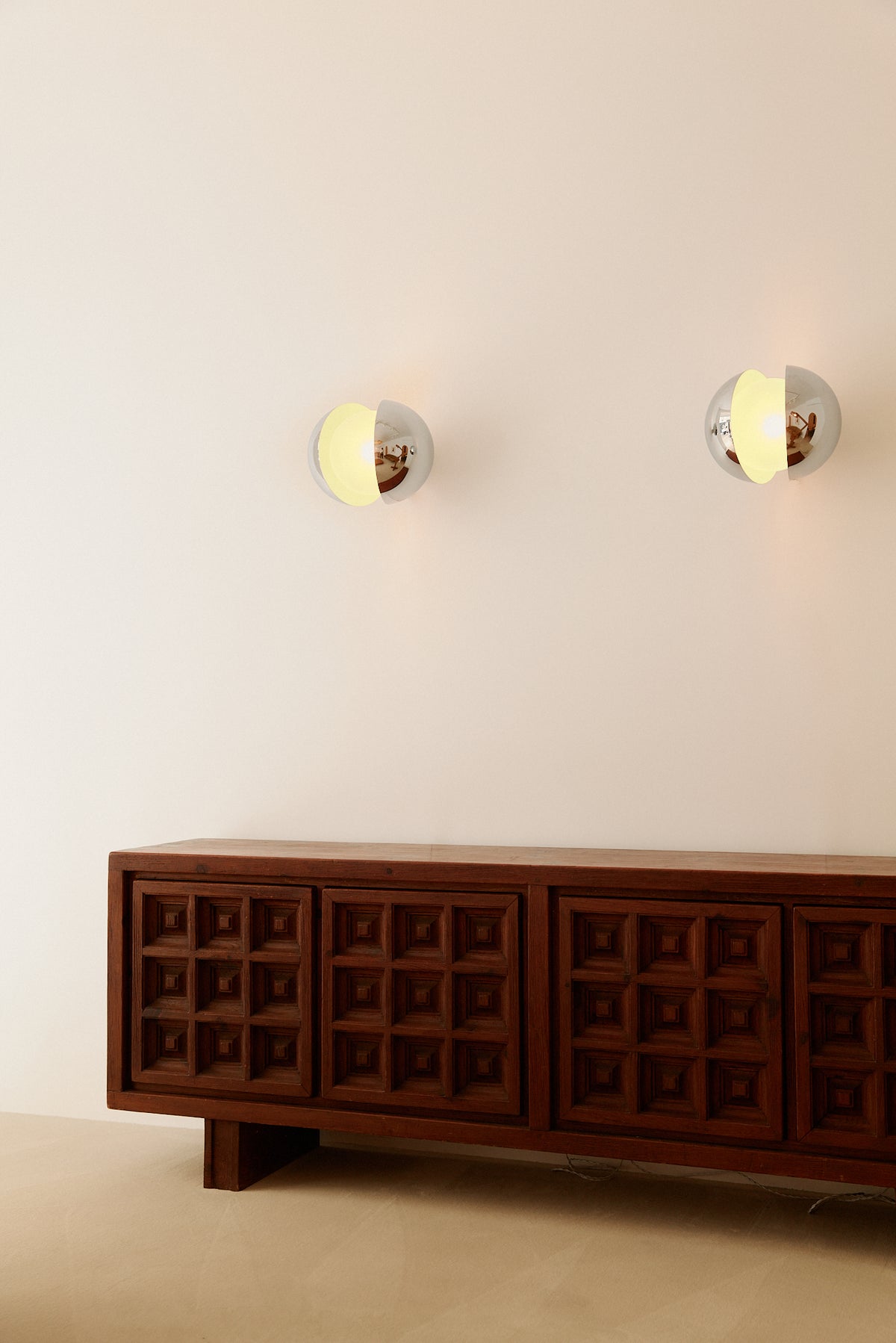 Gian Emilio, Piero & Anna Monti Diaframma polished steel and glass wall sconce, pair on the wall above a sideboard