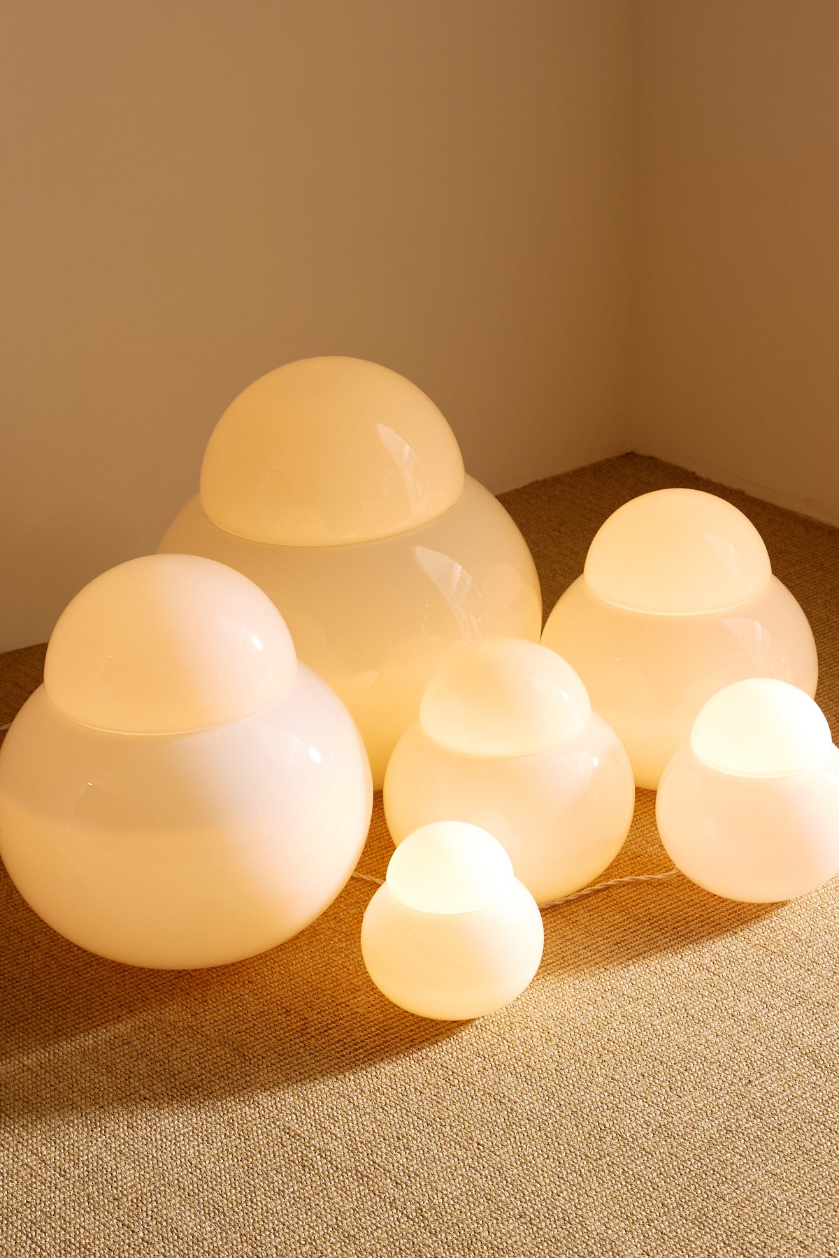 Sergio Asti frosted glass lamps, the group in the corner with the largest lamp behind