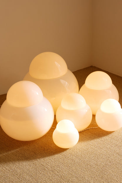 Sergio Asti frosted glass lamps, the group in the corner with the largest lamp behind