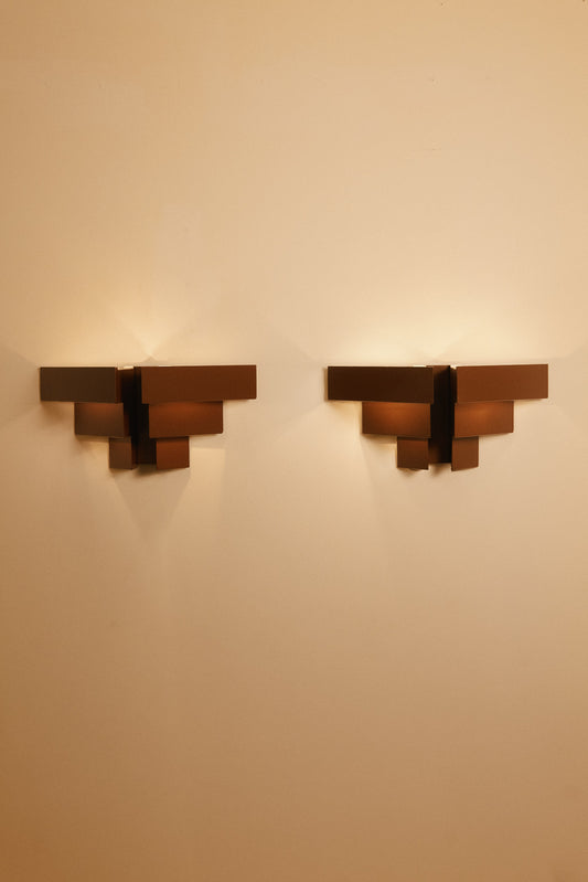 Stepped plate wall sconces, pair on the wall, lit