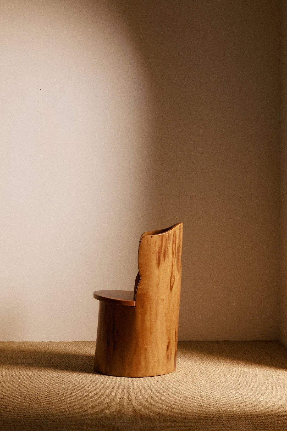 Swedish sculptural pine armchair, side view with the seat projecting to the left