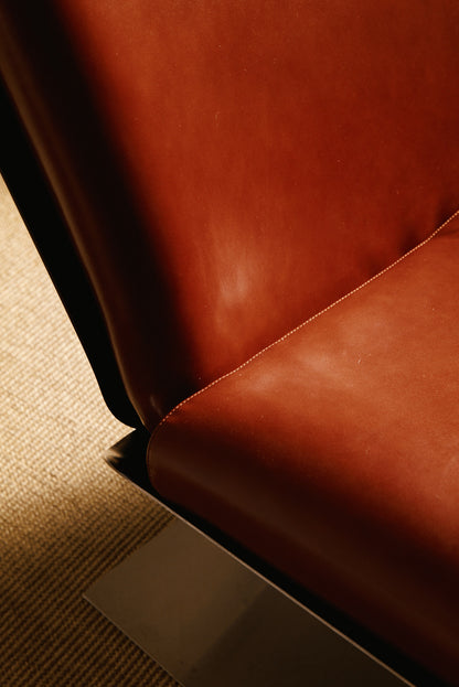 Xavier Féal cognac leather lounge chairs, close view of the leather seat and its seam