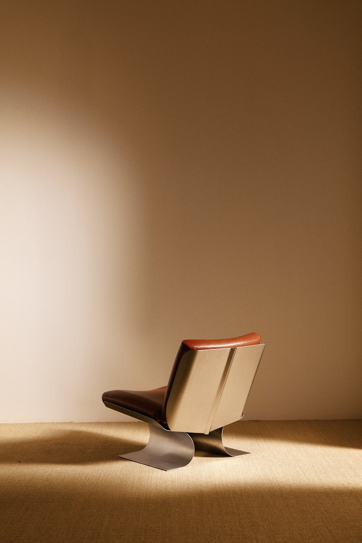 Xavier Féal cognac leather lounge chairs, single chair, closer rear angled view
