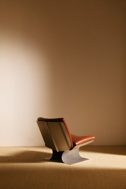 Xavier Féal cognac leather lounge chairs, single chair, rear angled view showing the steel back