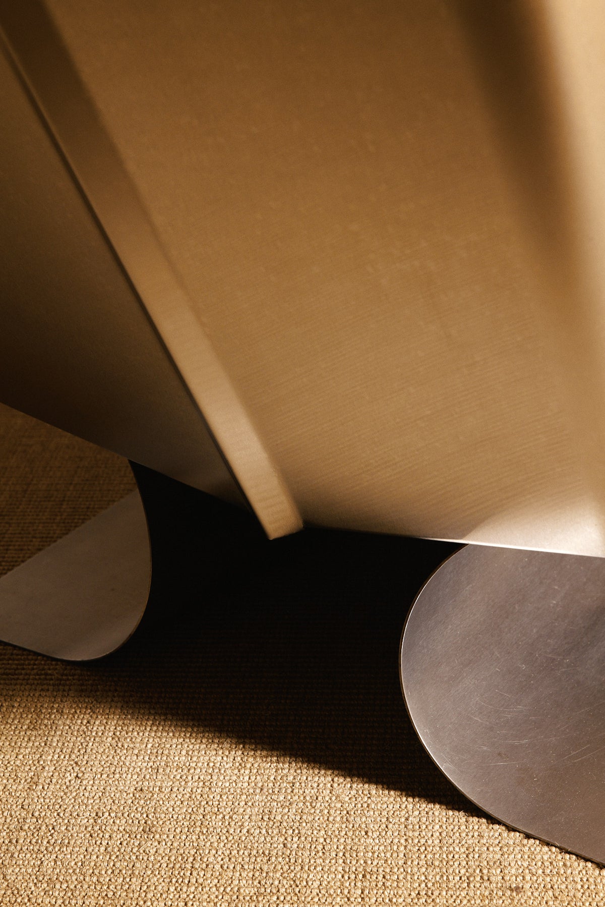 Xavier Féal cognac leather lounge chairs, close view of the curved steel base